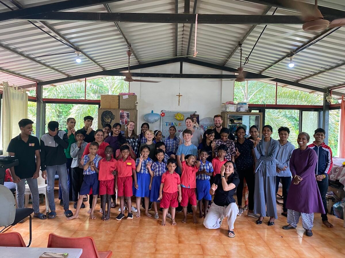 Family with teenagers volunteering together abroad during a volunteer vacation with private accommodation