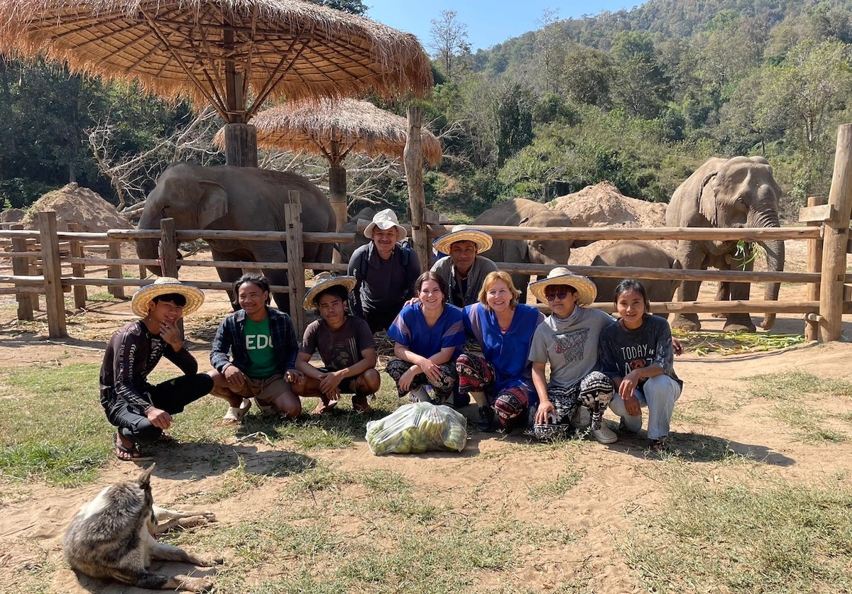Is Thailand a Good Destination for a Family Volunteer Vacation? Family volunteering together at a community project in Thailand with local children.