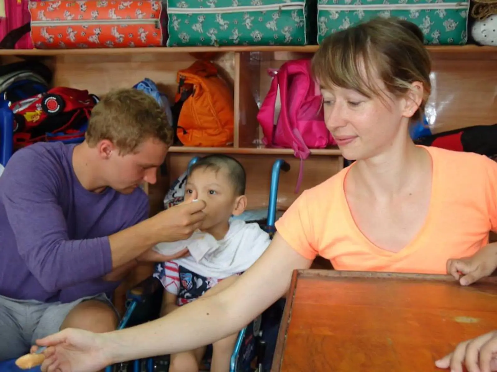 luxury family volunteer vacations A family caring for children during a luxury family volunteer vacation.