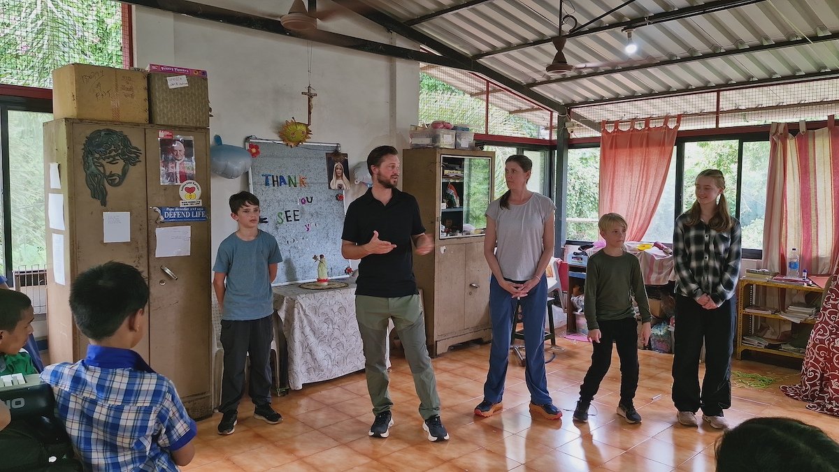 Family with teenagers volunteering together abroad during a volunteer vacation with private accommodation